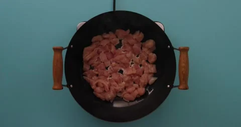 Adding pepper to chicken cooking in a skillet 1 Stock Footage 132198650