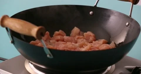 Adding pepper to chicken cooking in a skillet 2 Stock Footage 132198709