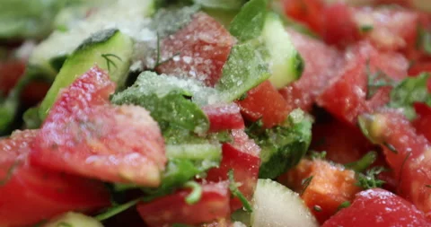 Adding pepper to a fresh vegetable salad Stock Footage 133835860