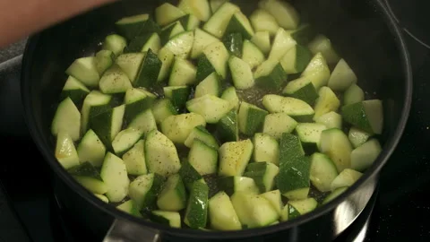 Adding Pepper to Zucchini While Frying in Pan Close Up Stockbeeldmateriaal 332860751