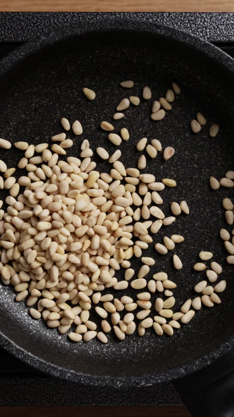 Adding Pine Nuts Into Pan Top View Vertical Stock Footage 337189854