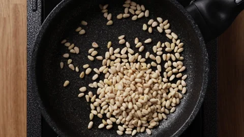 Adding Pine Nuts Into Pan Top View Видео 337190545