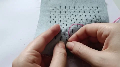 Adding Pink Thread to Black Sashiko Embroidery on Blue Fabric. 스톡 동영상 340122921