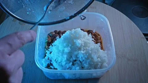 Adding Plain White Rice On Top Of Cooked... | Stock Video | Pond5