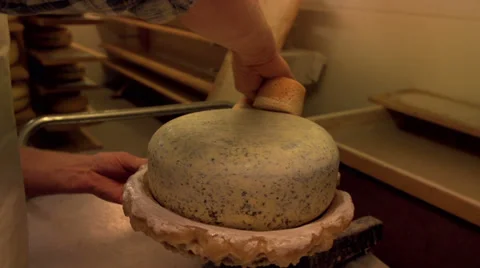 Adding a plastic coating to a cheese [Slomo] Stock Footage 36184917