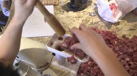 Adding pork cubes to meat grinder,  grinding pork for sausage 05 Stock Footage 45618428