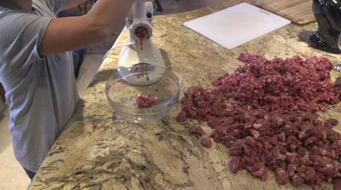 Adding pork cubes to meat grinder,  grinding pork for sausage 07 Stock Footage 45618464