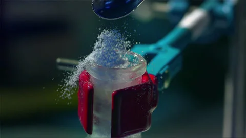 Adding a powder substance to a chemical experiment Stock Footage 257033333