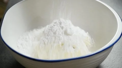 Adding powdered sugar to the mascarpone in the bowl. Stock Footage 244387018
