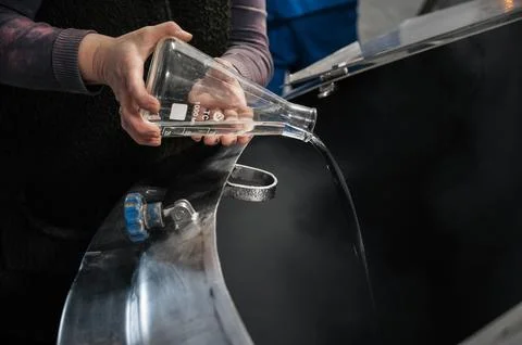 Adding prepared water in process of brewing beer in tank at beer production Stock Photos