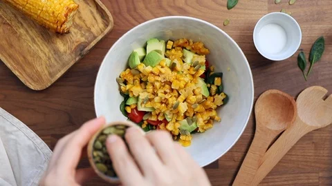 Adding pumpkin seeds to a bowl. Stock Footage 124264414