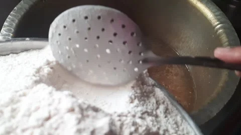 Adding Ragi Flour to Boiling Spiced Water for Papad Dough Preparation Video stock 333911326