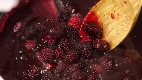 Adding raspberries to the pot. Stock Footage 141932627