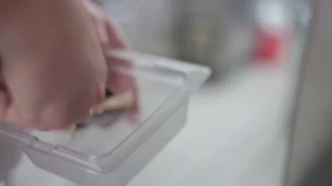 Adding raw fish in a pan full of mushrooms and vegetables Stock Footage 307340053