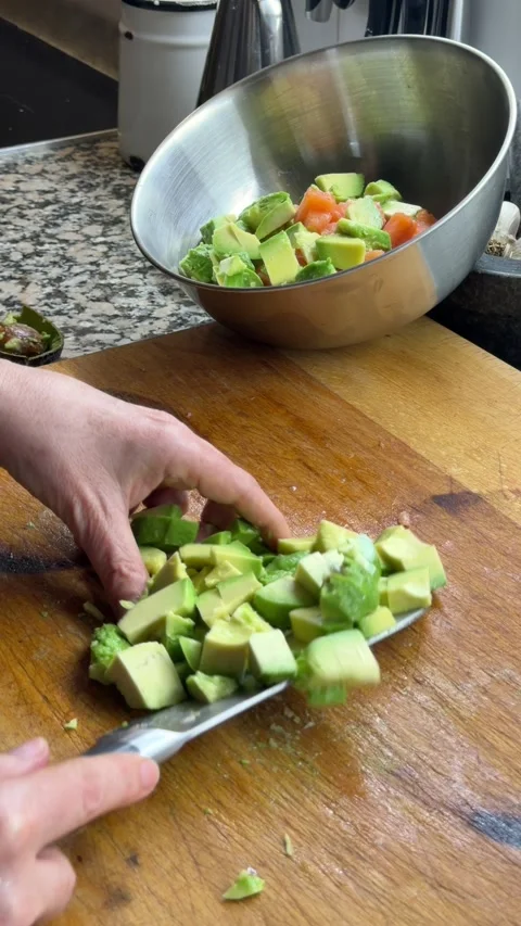 Adding raw salmon cubes into bowl for poke preparation Stock Footage 333263128