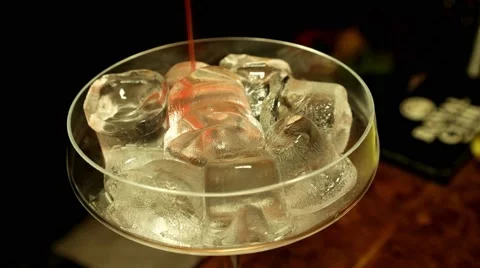 Adding red cocktail to the glass with ice Stock Footage 65366826