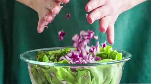 Adding red onion to salad Stock Footage 46932173