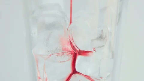 Adding red syrup to the glass with ice Stock Footage 91039883