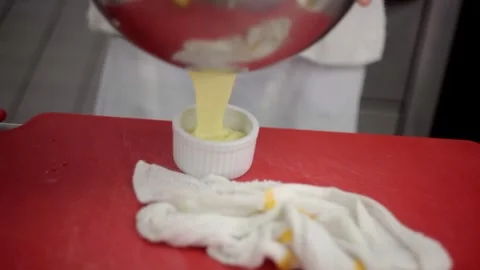 Adding the remaining sauce into a little container Stock-Footage 307340032