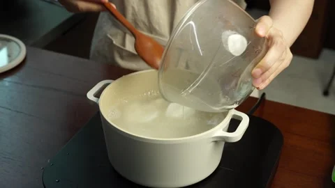 Adding Rice Cakes to Boiling Soup Stock Footage 334160100