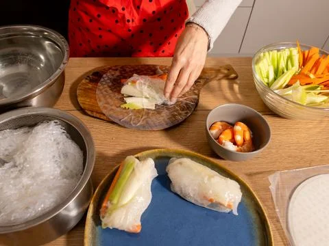 Adding rice noodles and vegetables to spring roll wrapper Stock Photos