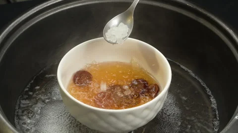 Adding Rock Sugar Into Steaming Cooked Bird Nest Soup In Pot Stock Footage 339405890