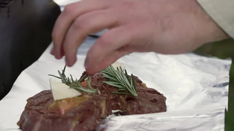 Adding rosemary to hot steak. Stock Footage 277108283