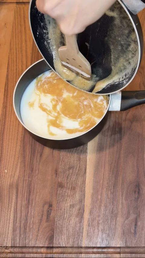 Adding Roux Mixture into Milk in Saucepan Vertical Cooking Video Видео 334803397