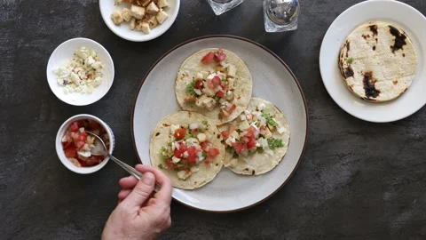Adding Salsa to a Plate of Mexican Street Tacos Stock Footage 189377754