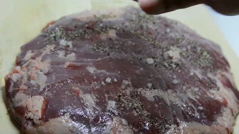 Adding salt and seasoning to beef.salt and pepper a peace of fresh meat Video stock 139980824