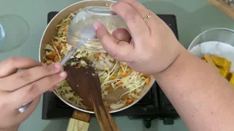 Adding Salt and Seasoning to Stir Fried Bean Sprouts Asian Cooking Process Stock Footage 310351914