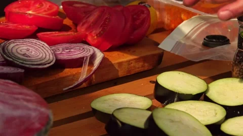 Adding salt and slicing vegetables Stock Footage 248301108