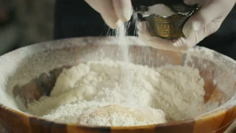 Adding salt and sugar to dough mix Stock Footage 138127006