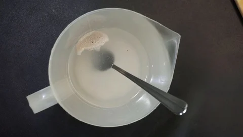 Adding salt and yeast overhead Stock Footage 121119324