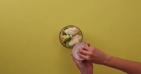 Adding salt to blender of chickpeas, avocados, lime, and tahini 1 Video stock 132207716