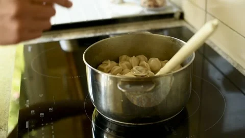 Adding Salt to Boiling Dumplings Stock-Footage 314711386