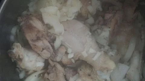 Adding salt to braised chicken overhead Stock Footage 121118512
