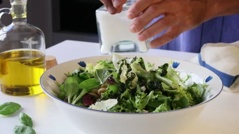 Adding salt flakes in a salad bowl. Stock Footage 195951066