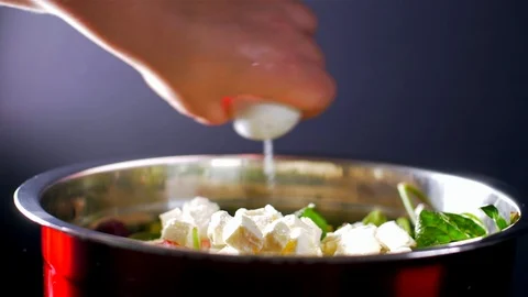 Adding salt to a mix of salads. Slow motion Stock-Footage 108144513