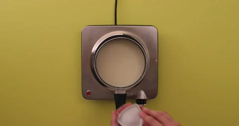 Adding salt, pepper, and nutmeg to a white sauce Stock Footage 132146442