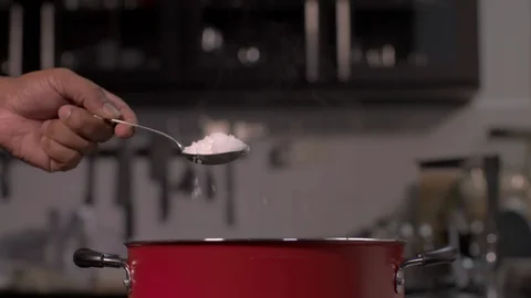 Adding Salt to a Pot Stock Footage 122856335