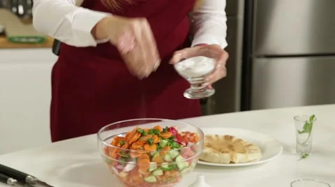 Adding salt to the salad Stock Footage 49782490