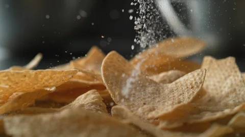 Adding salt on tortilla chips. Slow Motion. Stock Footage 89611451