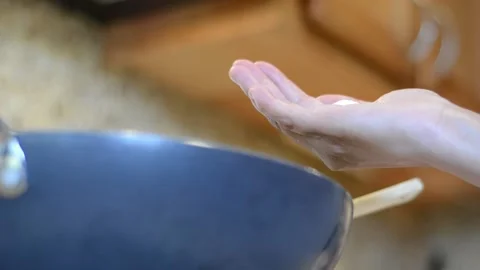 Adding Salt to the Wok Stock Footage 136059312