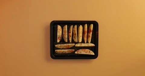 Adding salta and pepper to the potatoes Stock Footage 132145492