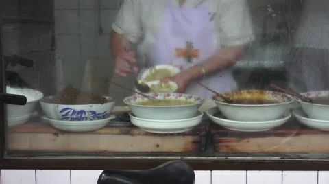 Adding Sauce And Herbs To Bowls Of Chinese Noodles View From Restaurant Window 스톡 동영상 56700772