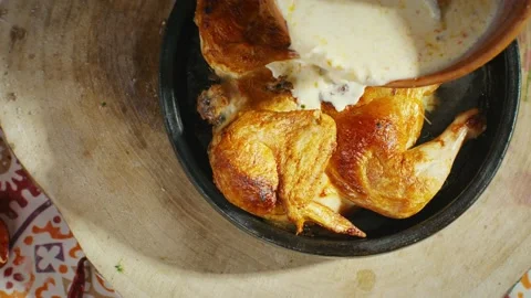 Adding sauce to fried chicken for Georgian dish Shkmeruli Stock Footage 138127837