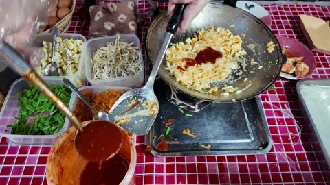 Adding Sauce to Pad Thai in Wok with Fresh Ingredients 4K Thai Street Food Stock-Footage 333189259