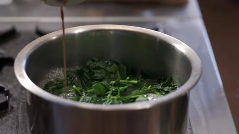 Adding sauce into a soup pot Stock Footage 145354728