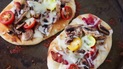 Adding scallions to and cutting up pizza Stock Footage 91447567